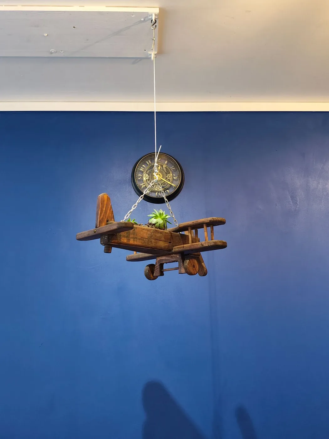 Avion en bois suspendu et horloge à engrenages